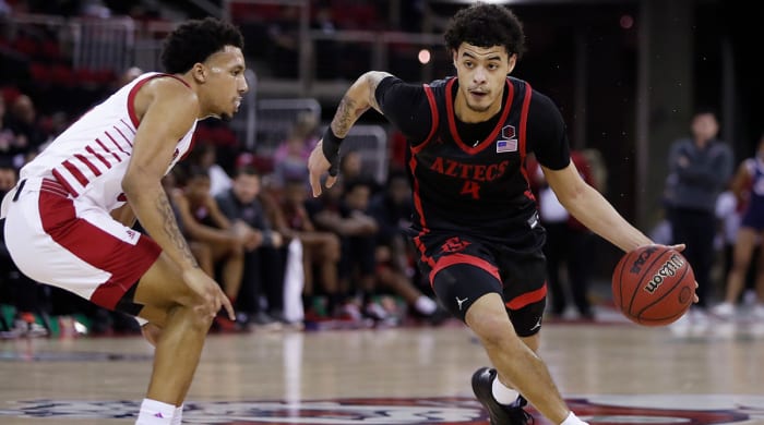 San Diego State's Trey Pulliam, right, drives past a Fresno State's defender during the first half of an NCAA college basketball game in Fresno, Calif., Saturday, Feb. 19, 2022.